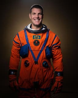 Jeremy Hansen posing in astronaut uniform